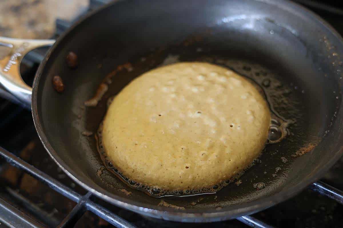 Pancake cooking in a skillet. 