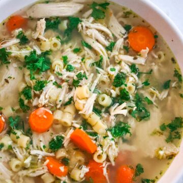 chicken ditalini soup in a white bowl.