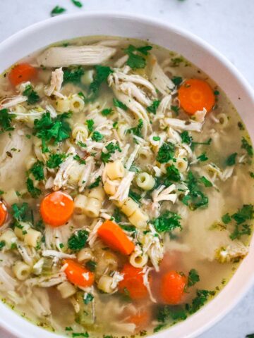 chicken ditalini soup in a white bowl.