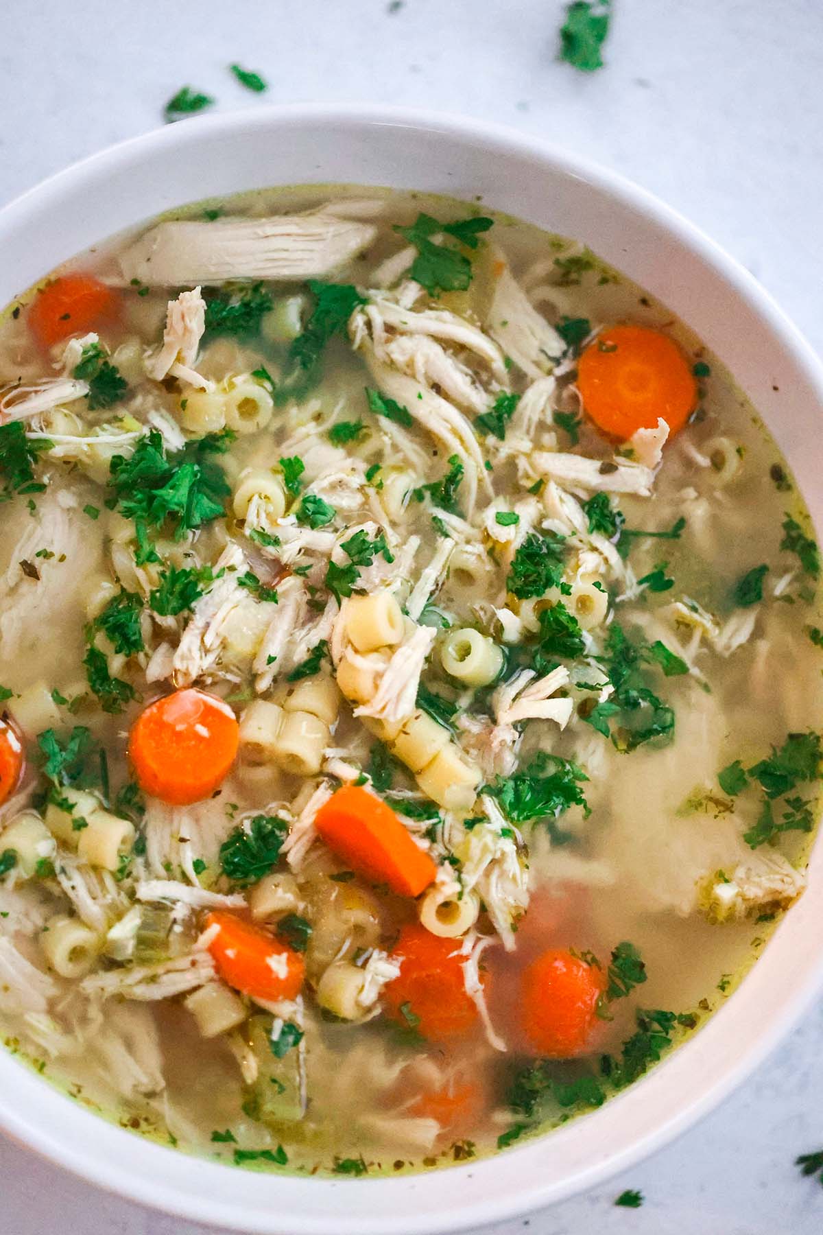 chicken ditalini soup in a white bowl. 