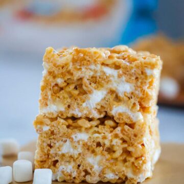 two rice krispie treats stacked with marshmallows on the side.