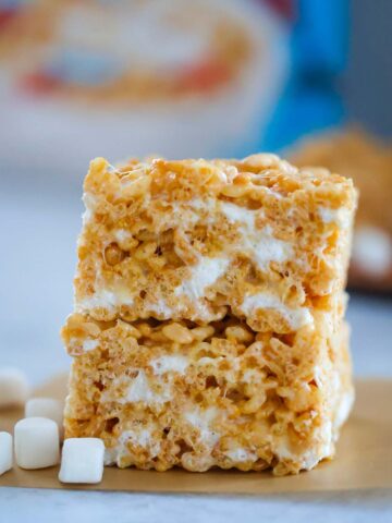 two rice krispie treats stacked with marshmallows on the side.