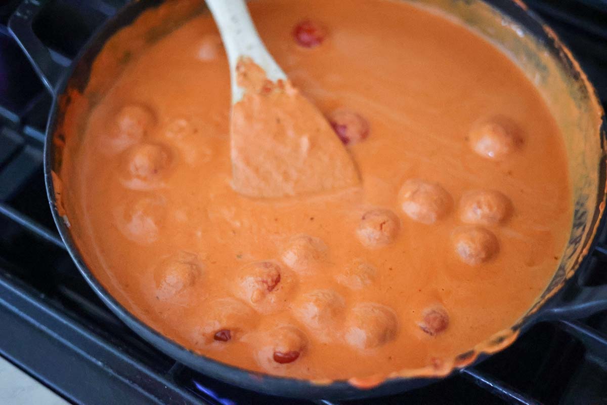 creamy vodka sauce cooking in the skillet. 