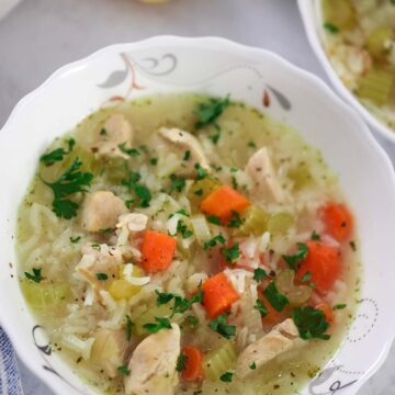a small bowl of chicken and rice soup up close.