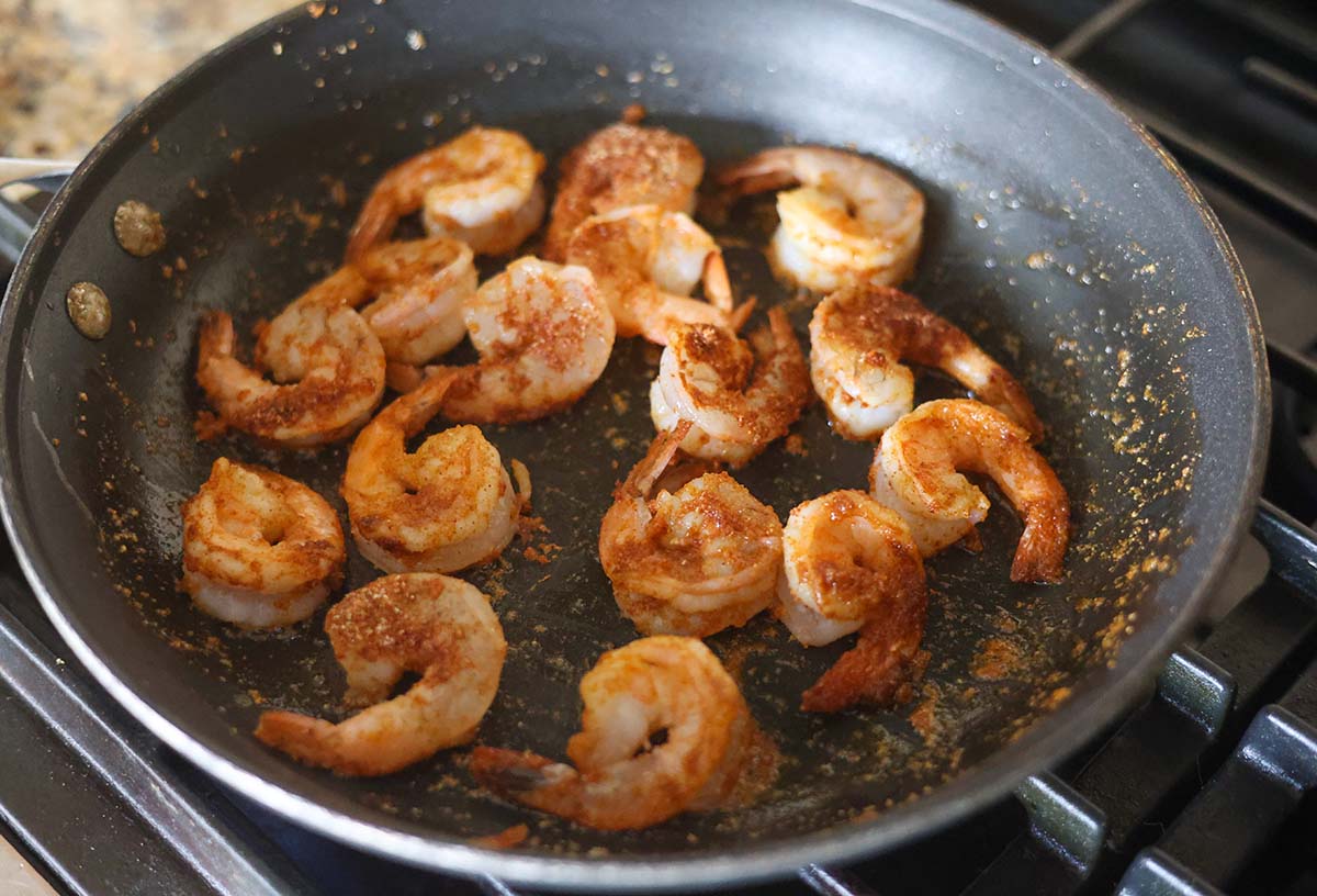 shrimp in a skillet cooking on the stovetop. 