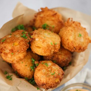 sweet crab hush puppies with sauce on the side.