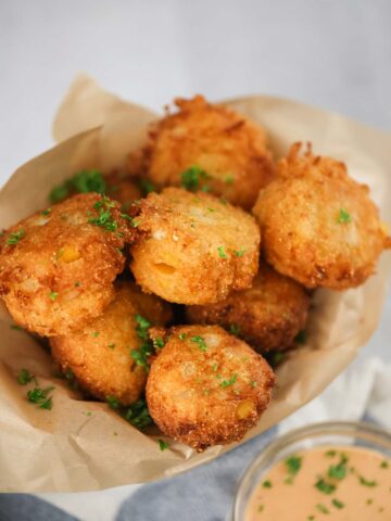 sweet crab hush puppies with sauce on the side.