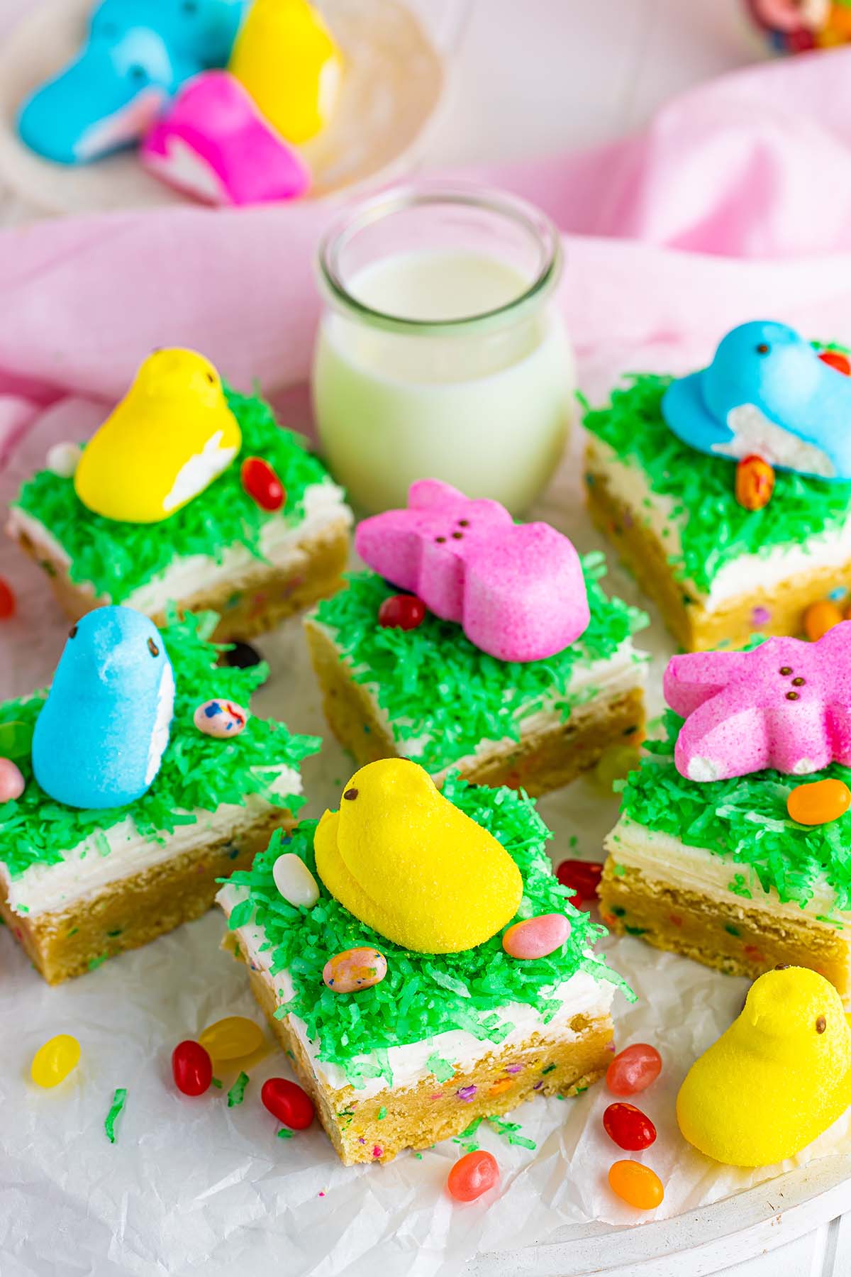 Easter sugar cookie bars with jelly beans, milk, and peep candies on the side. 