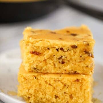 two slices of caramelized onion cornbread on a plate.