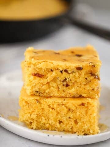 two slices of caramelized onion cornbread on a plate.