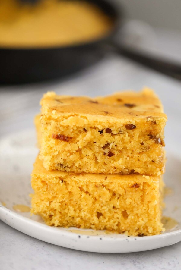 two slices of caramelized onion cornbread on a plate.