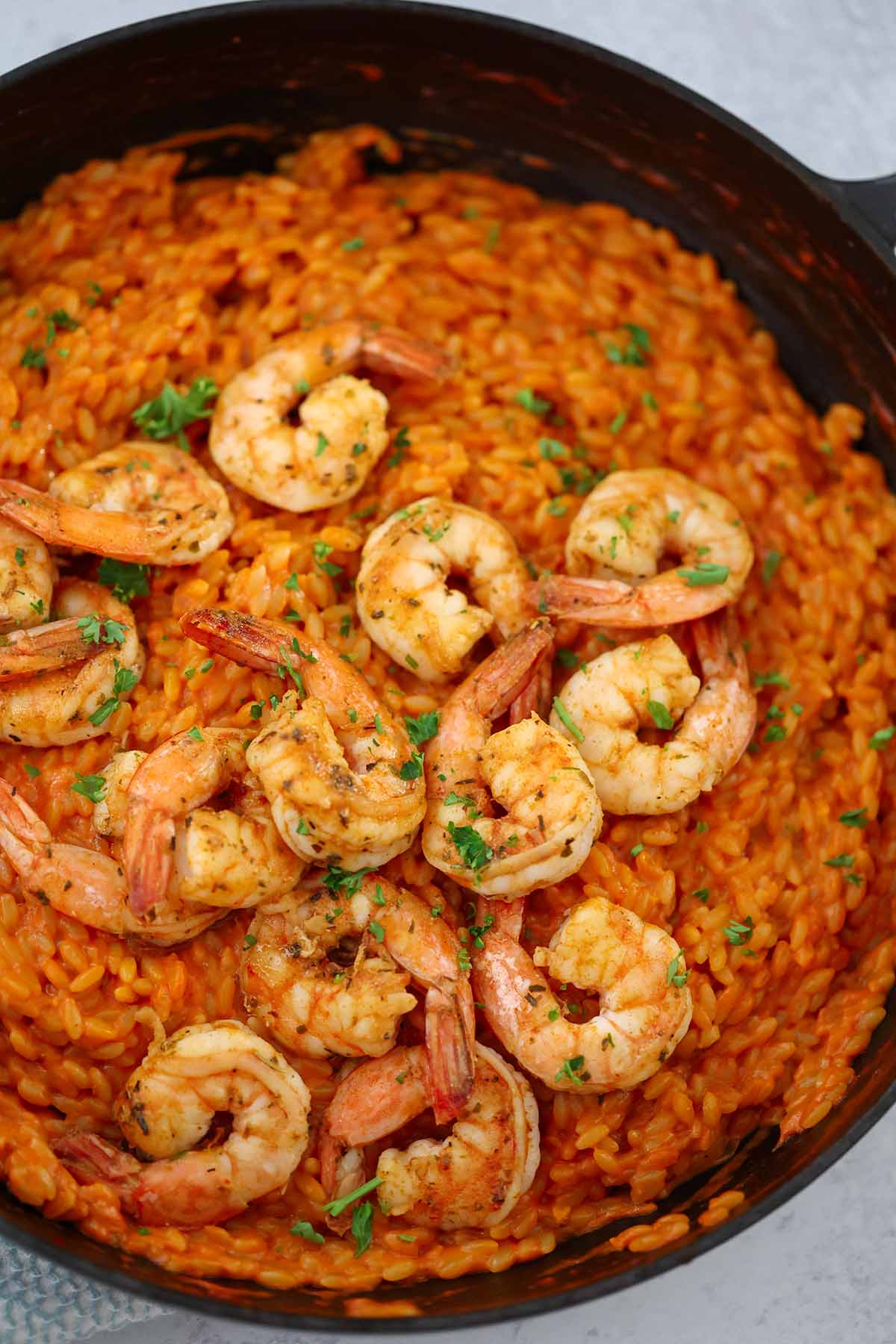 orzo with shrimp in a skillet. 
