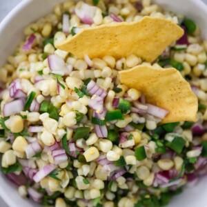 roasted chili corn salsa in a bowl with tortilla chips.