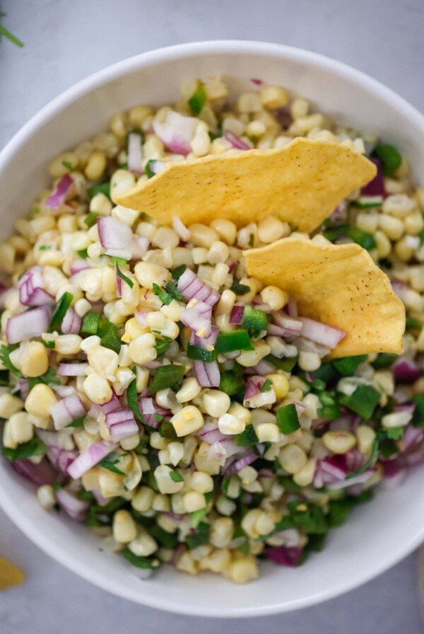 roasted chili corn salsa in a bowl with tortilla chips.