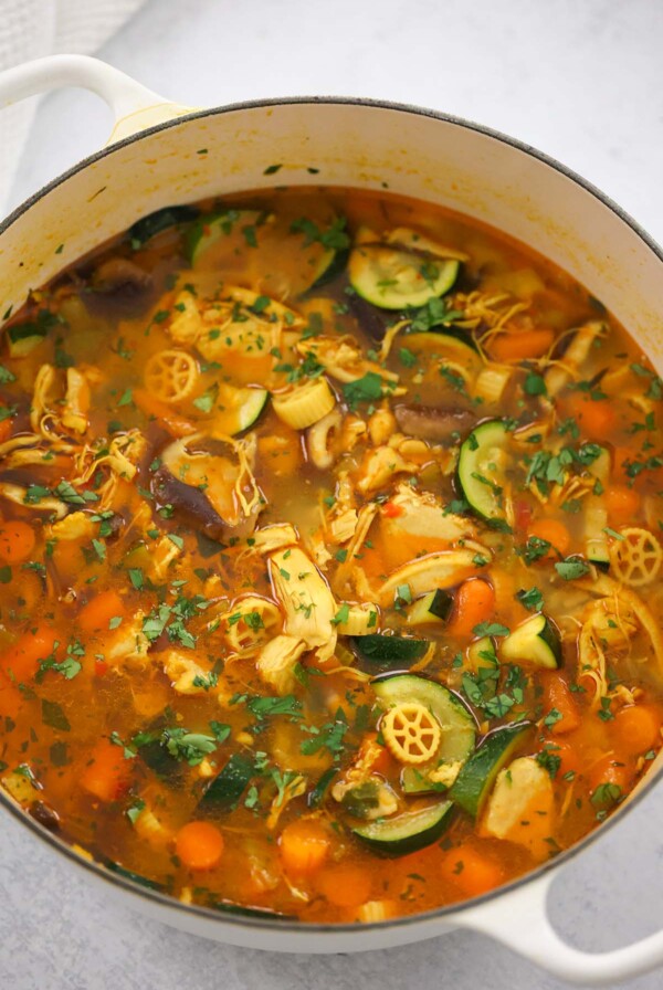 spicy chicken noodle soup in a dutch oven.