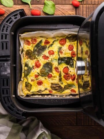 A frittata in an air fryer basket.