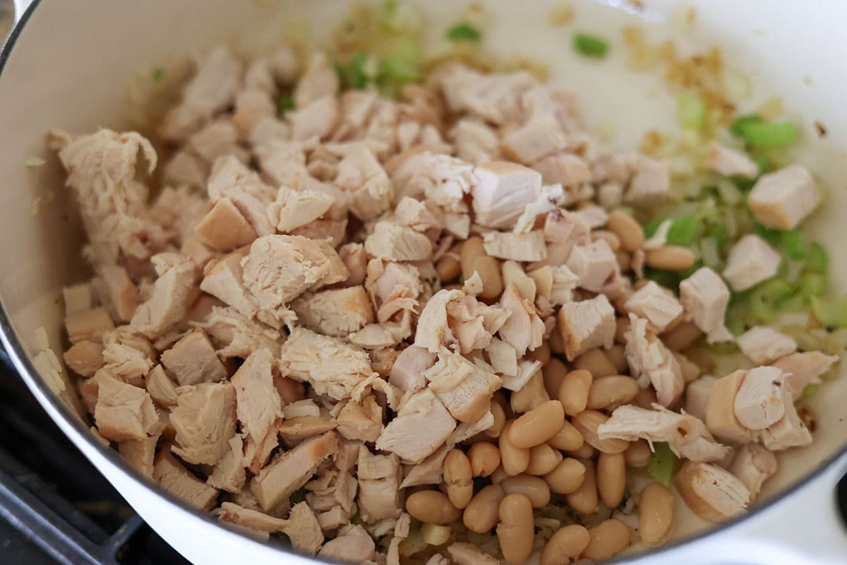 chicken, beans, onions, and celery in a dutch oven. 