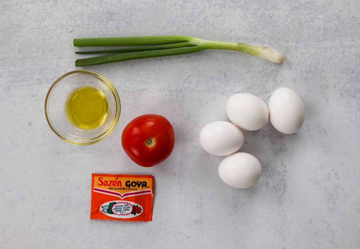 four eggs, tomato, scallions, and sazon. 