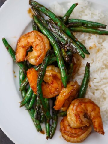 honey shrimp and green beans with white rice on the side.