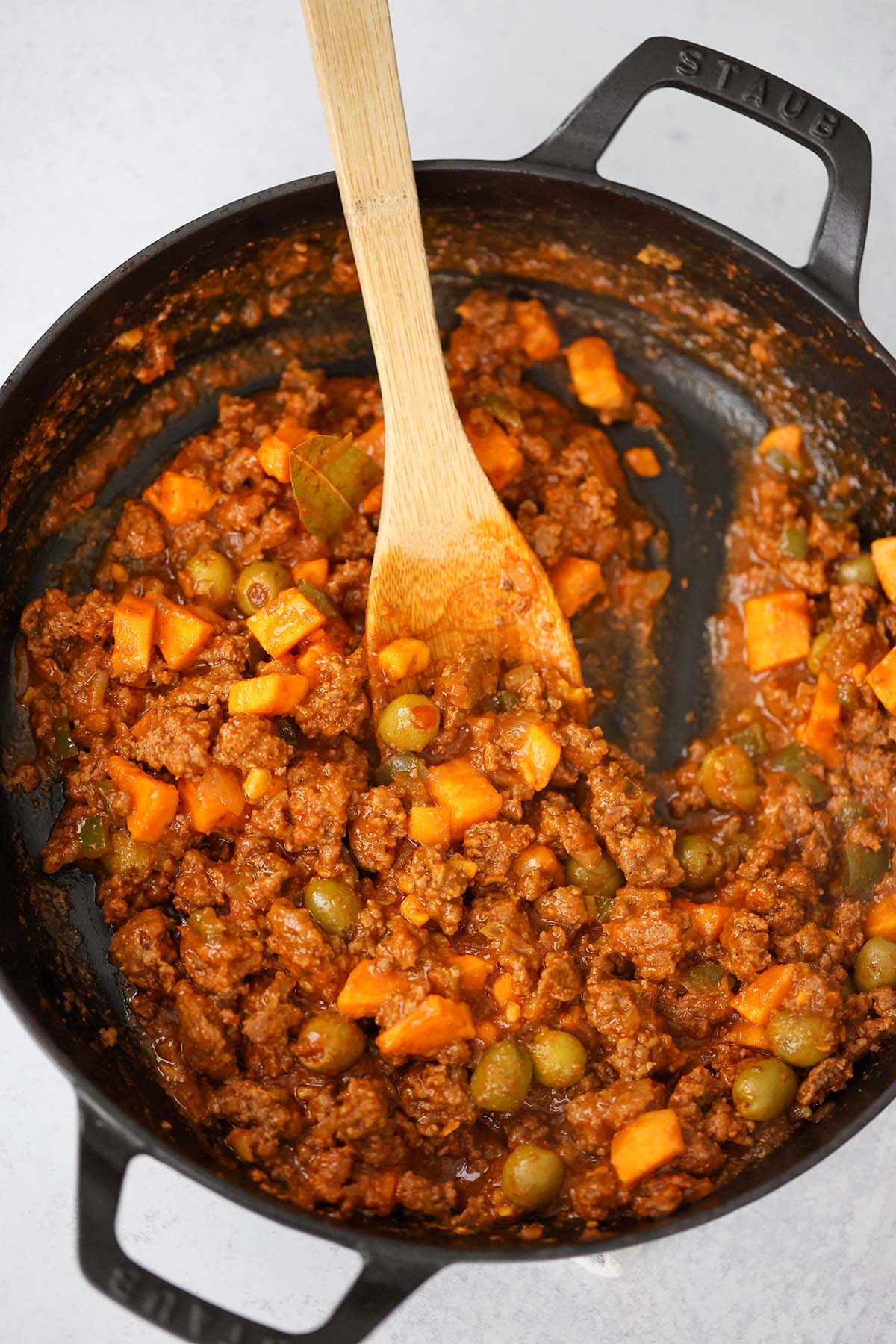 ground beef with sweet potatoes in a skillet. 