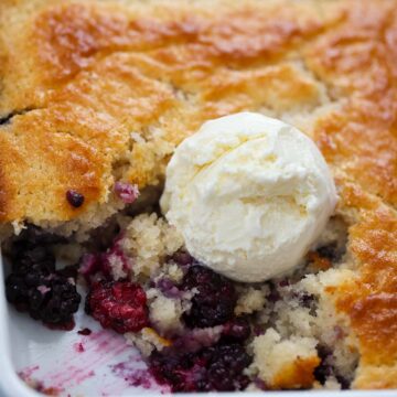 blackberry cobbler with vanilla ice cream on top.