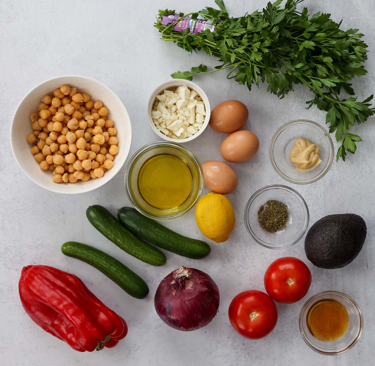 Ingredients for chickpea salad on a white surface. 
