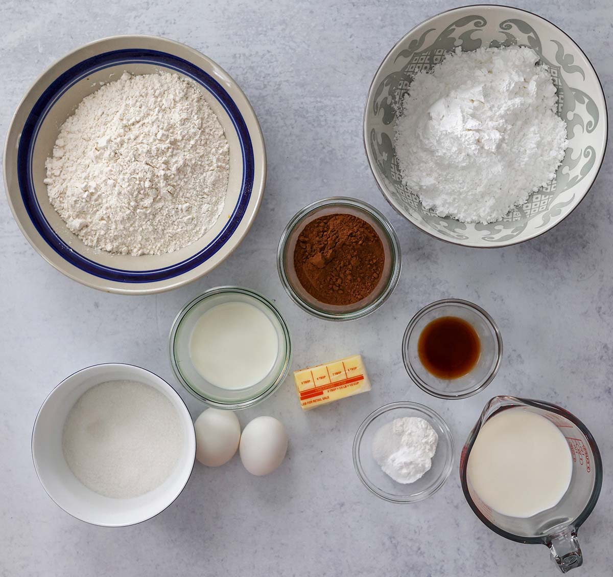 flour, sugar, milk, eggs, butter, cocoa powder, vanilla extract, salt, baking soda, and baking powder. 