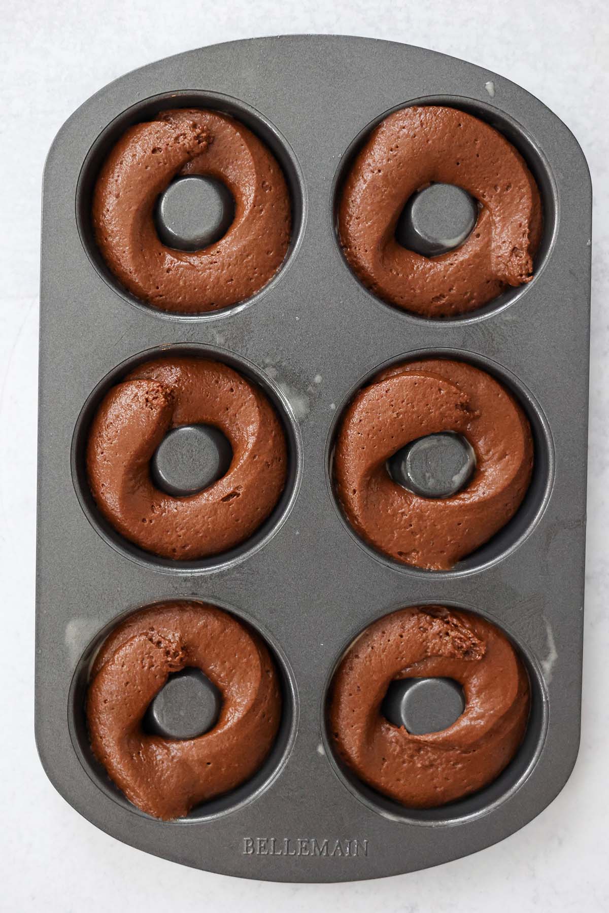 a donut pan filled with donut batter. 
