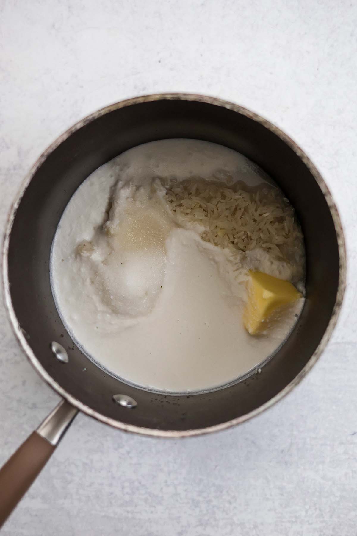 rice, butter, sugar, salt, and coconut milk in a saucepan. 