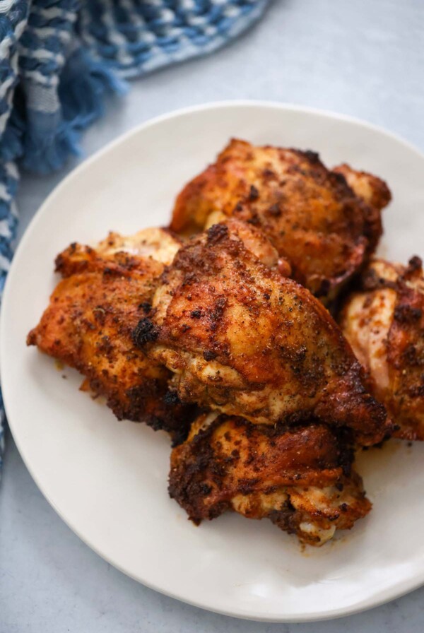 roasted chicken thighs on a white plate.