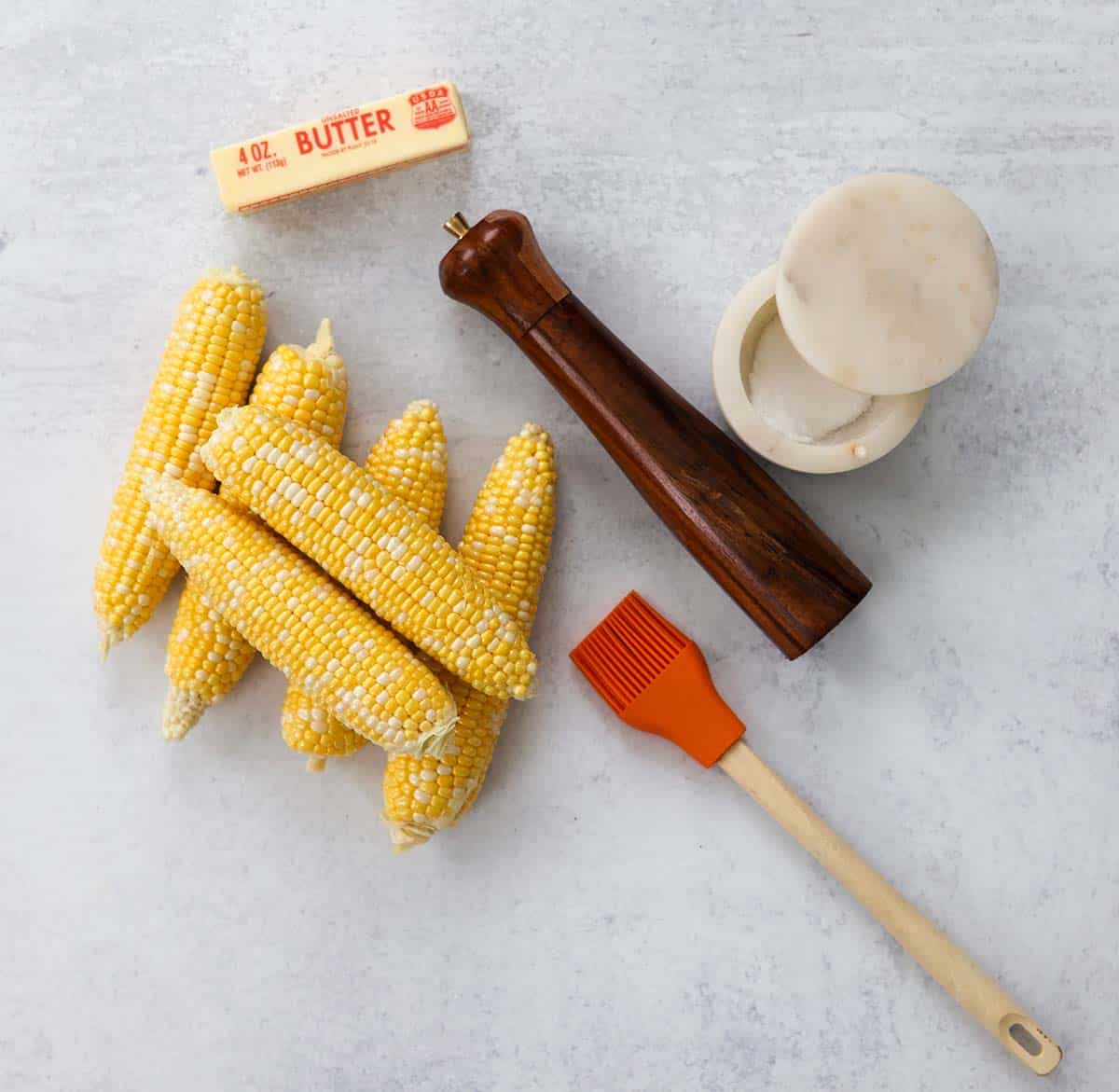 6 ears of corn, salt, pepper, butter, and a brush. 