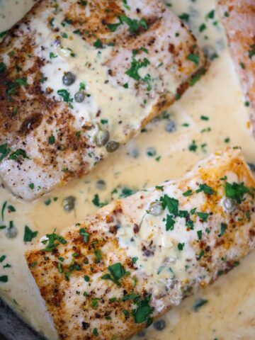 creamy mahi mahi fillets in a skillet.