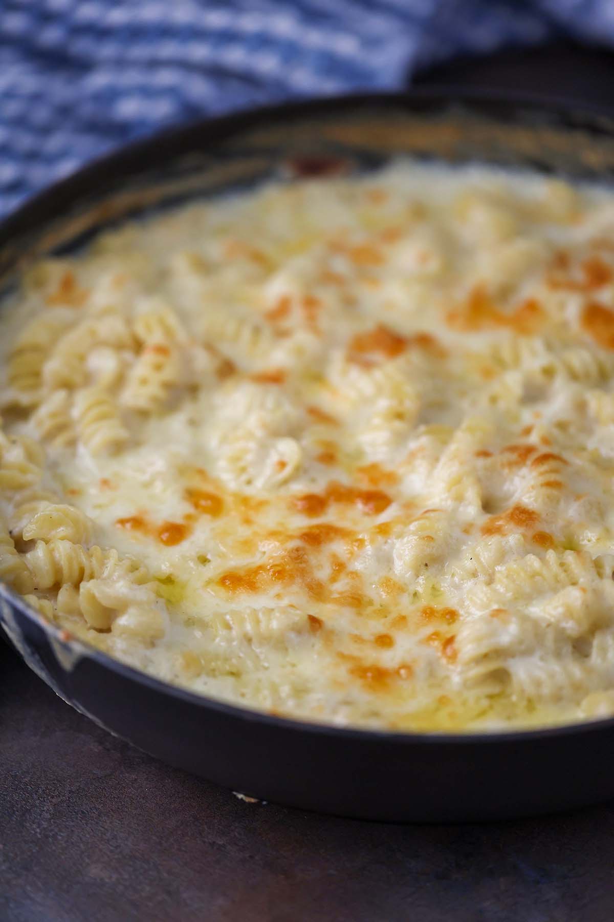 white cheddar mac and cheese in an iron skillet. 