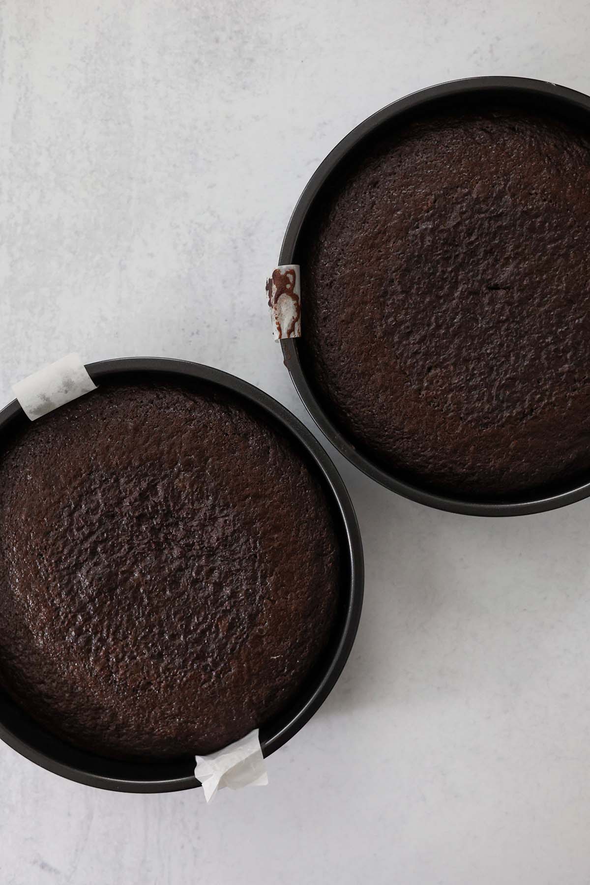 Two nine inch baked chocolate cakes. 