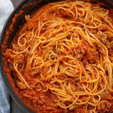 ground turkey spaghetti in a black skillet.