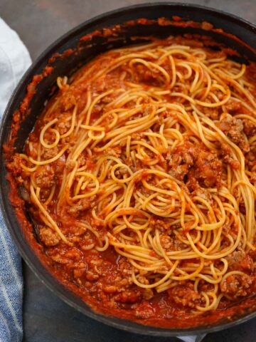 ground turkey spaghetti in a black skillet.