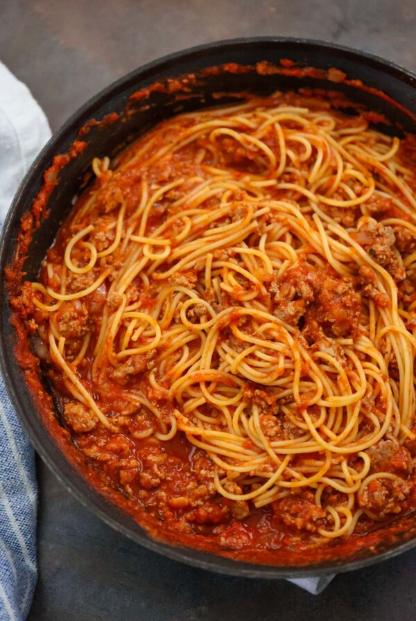 ground turkey spaghetti in a black skillet.