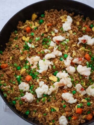 Lobster fried rice in a black skillet.