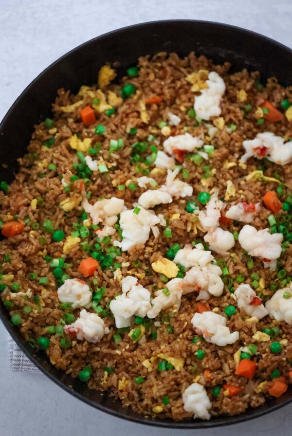 Lobster fried rice in a black skillet.