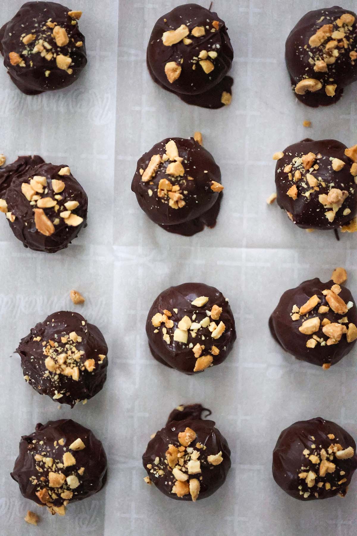 Peanut butter balls covered in dark chocolate and topped off with crushed peanuts. 