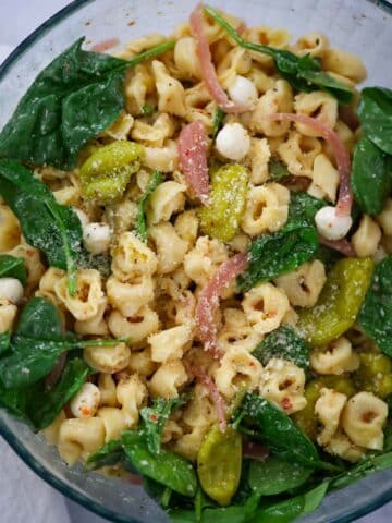 tortellini pasta salad in a glass bowl.