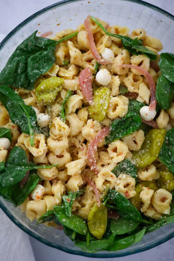 tortellini pasta salad in a glass bowl.