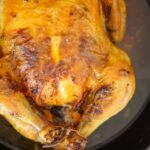 Cuban butter roast chicken in a cast iron skillet.
