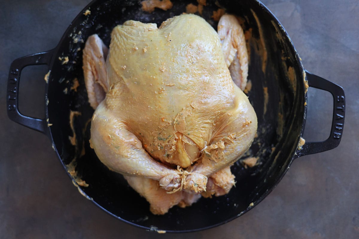 Whole raw chicken smothered in flavored butter. 