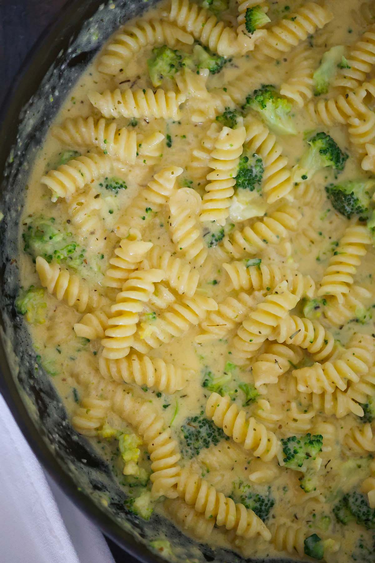 broccoli cheddar pasta in a skillet. 