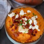 mashed sweet potatoes with goat cheese and bacon on top.