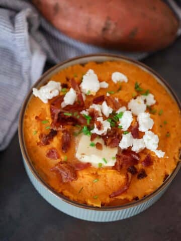 mashed sweet potatoes with goat cheese and bacon on top.