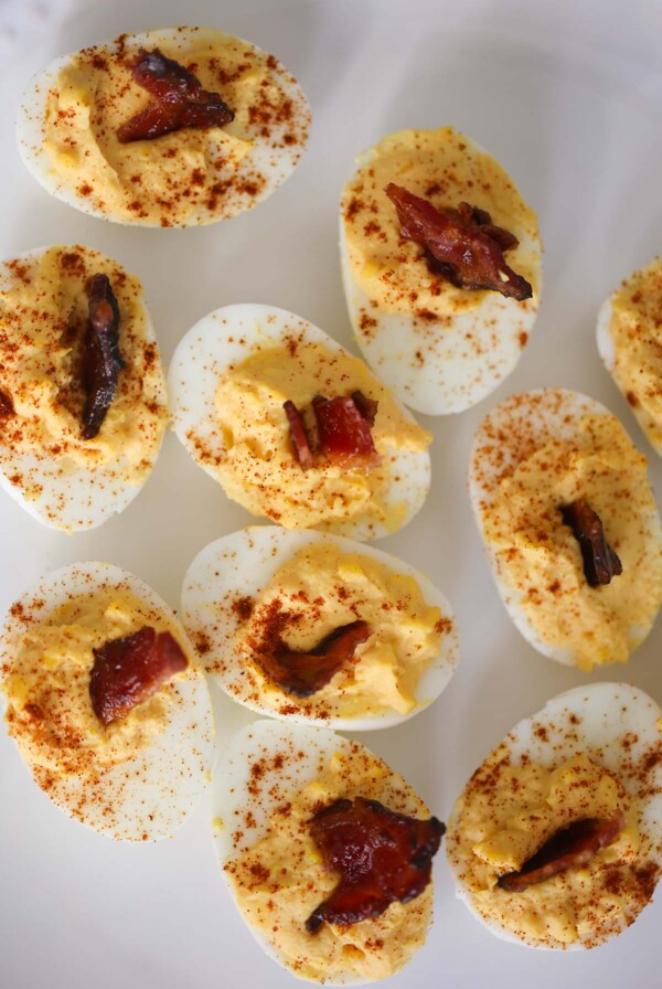 million dollar deviled eggs with bacon on top.
