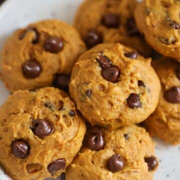 pumpkin chocolate chip cookies on a plate.