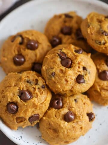pumpkin chocolate chip cookies on a plate.